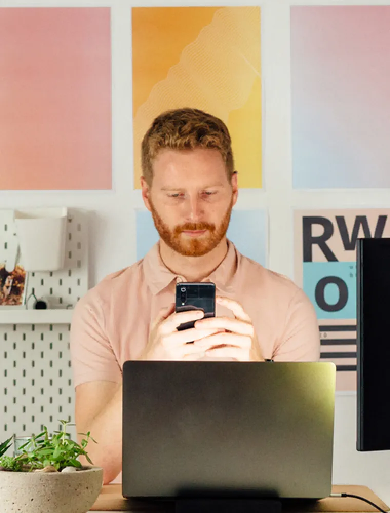 Person thinking while working at a laptop
